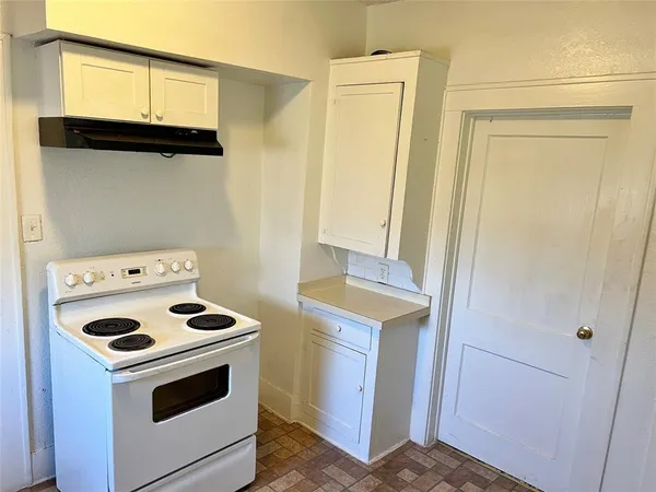 a kitchen with a stove and a cabinet