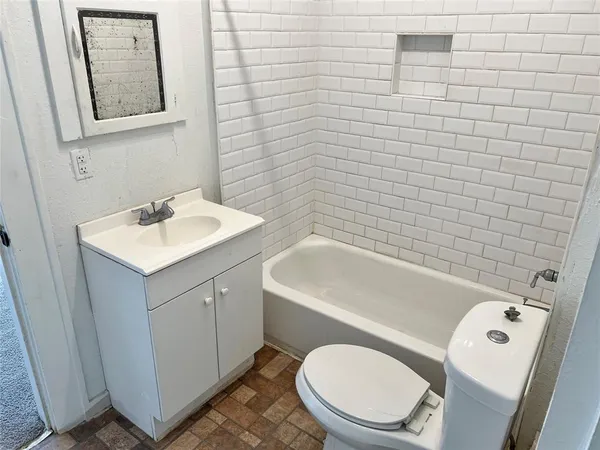 a bathroom with a sink a toilet and mirror