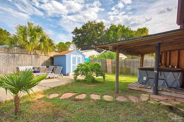 a view of a backyard with sitting area