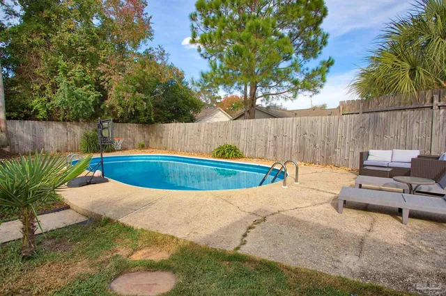 a view of a backyard with swimming pool
