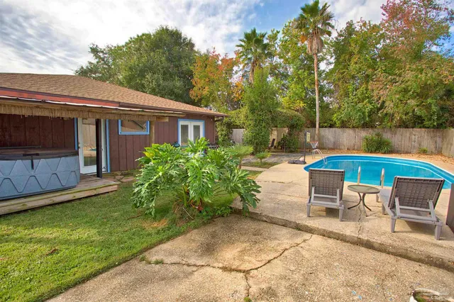 a backyard of a house with yard barbeque oven and outdoor seating