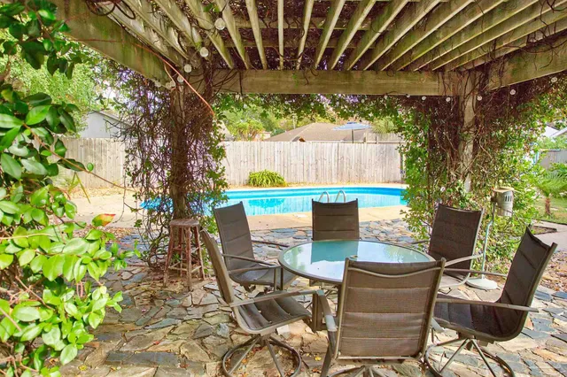 a view of backyard with outdoor seating and green space