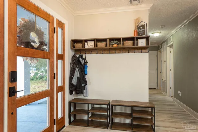 a view of a hallway with wooden floor and windows