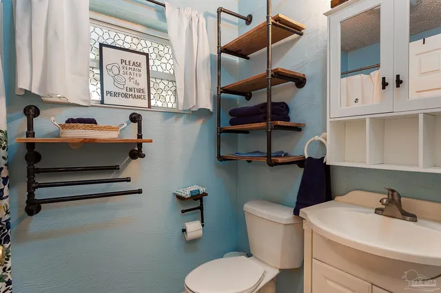 a bathroom with a toilet and a sink