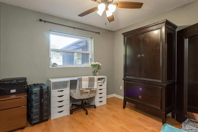 a view of a workspace with furniture and a window