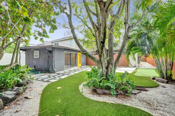a front view of a house with a garden