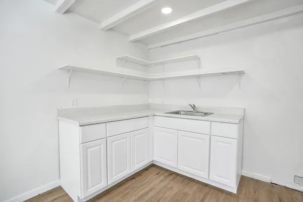 a room with a sink cabinets and utility room