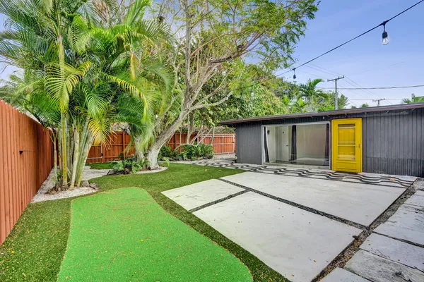 a view of a house with a yard and a garage