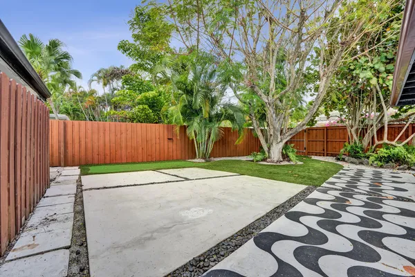 a white house with tree in front of it