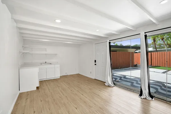 a view of room with wooden floor and window