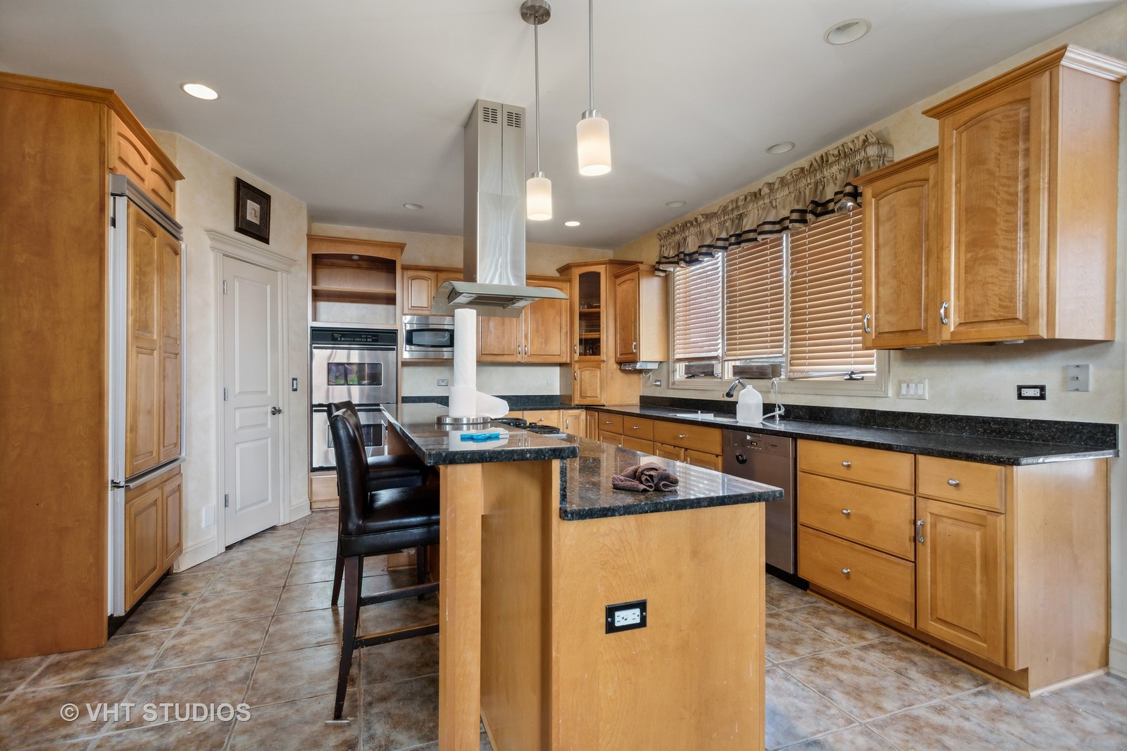 15365 Dan Patch Drive Plainfield, IL 60544 - Photo 7 of 30 a kitchen with stainless steel appliances granite countertop a refrigerator a sink dishwasher a stove and a dining table with wooden floor