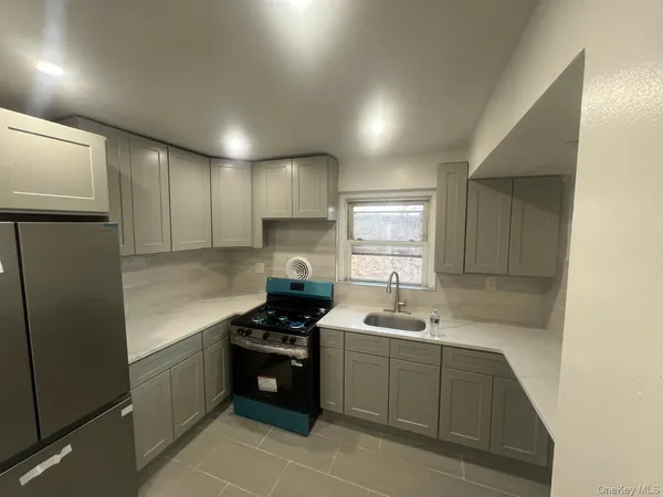 a kitchen with a sink cabinets and stainless steel appliances
