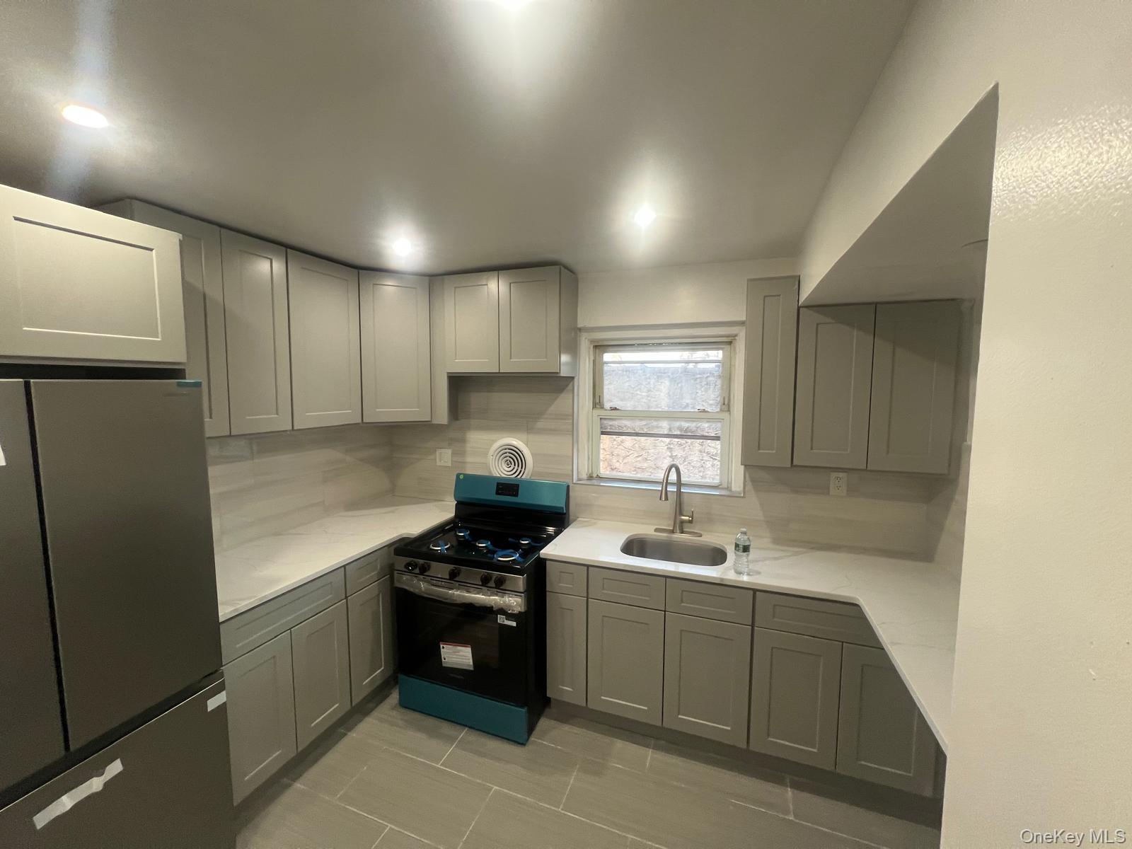 a kitchen with a sink cabinets and stainless steel appliances