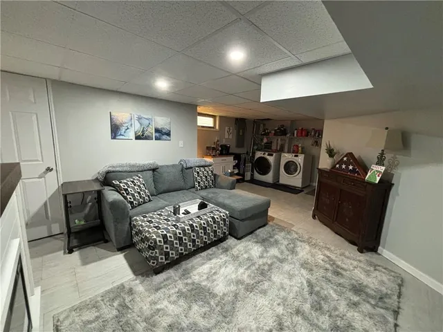 a view of a livingroom with furniture and a flat screen tv