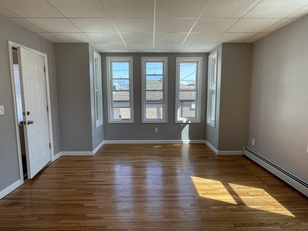 857 2nd Street Fall River, MA 02721 - Photo 5 of 38 a view of empty room with wooden floor and fan