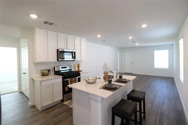 a kitchen with a sink stove and refrigerator