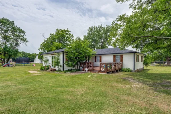 a view of a house with a yard and sitting area