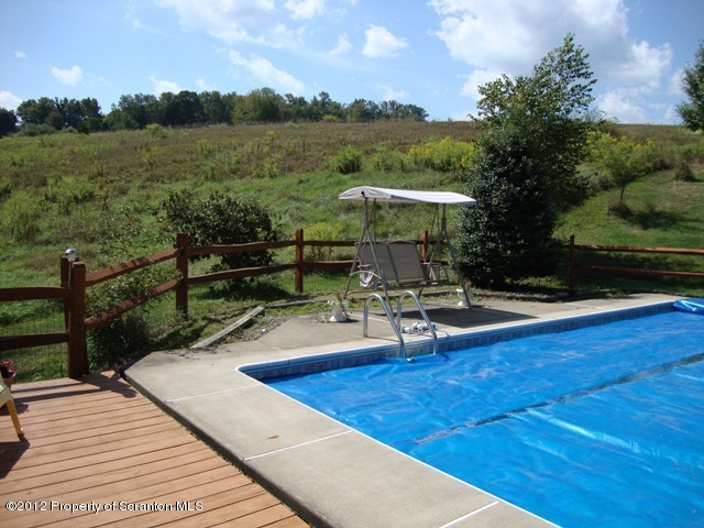 886 State Rte 4002 Laceyville, PA 18623 - Photo 35 of 44 a view of a patio with chairs and wooden floor