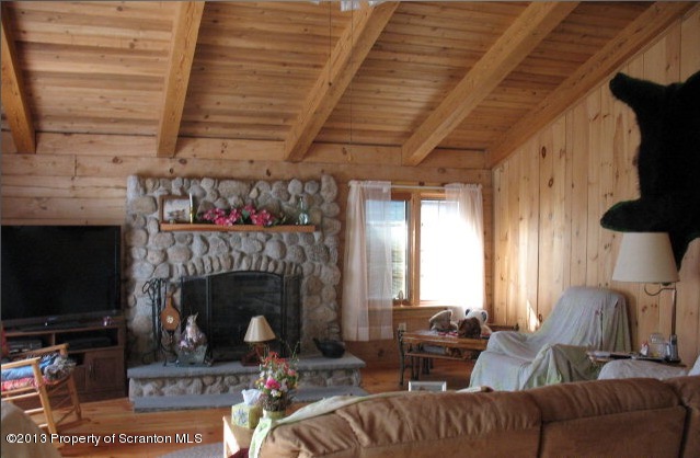 886 State Rte 4002 Laceyville, PA 18623 - Photo 42 of 44 a living room with furniture a fireplace and a flat screen tv