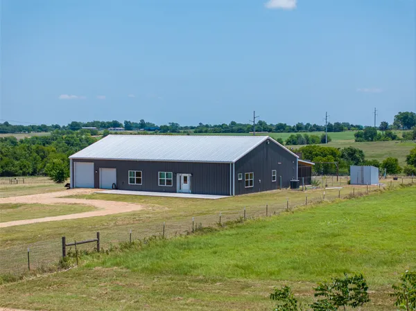 a front view of house with outdoor space and trees around