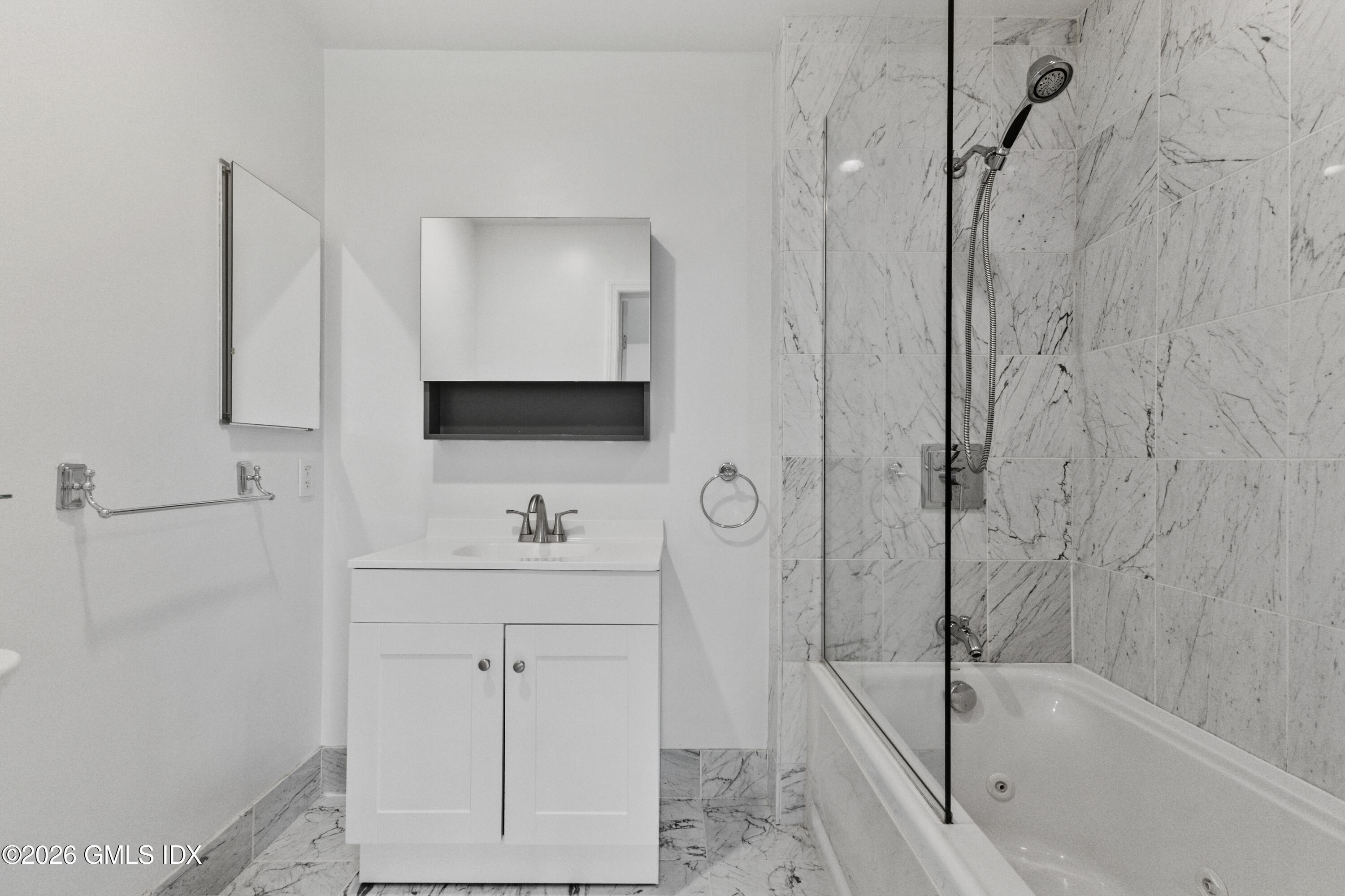 15 River Road, Unit 210 Cos Cob, CT 06807 - Photo 18 of 23 a bathroom with a bathtub a sink a vanity and a shower