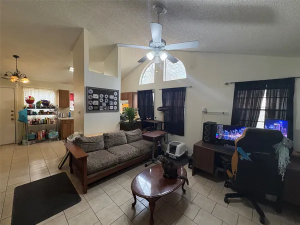 a living room with furniture and a chandelier