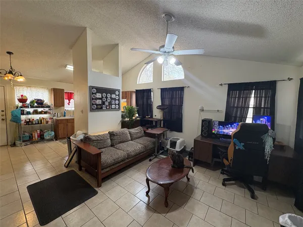 a living room with furniture and a ceiling fan