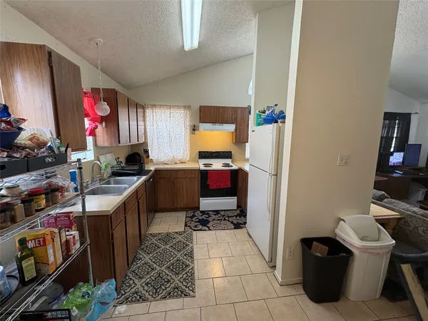 a kitchen with a refrigerator stove and sink