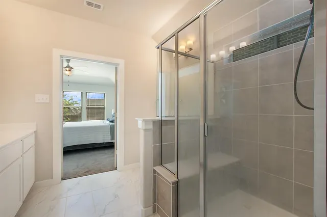 a bathroom with a shower and a sink