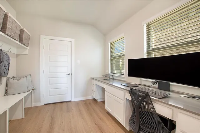 a view of a workspace with furniture and a flat screen tv