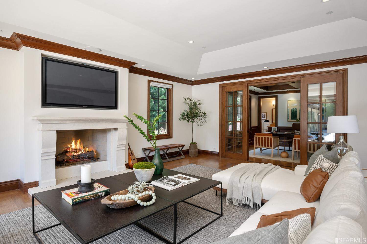 73 Irving Avenue Atherton, CA 94027 - Photo 38 of 99 a living room with furniture a flat screen tv and a fireplace