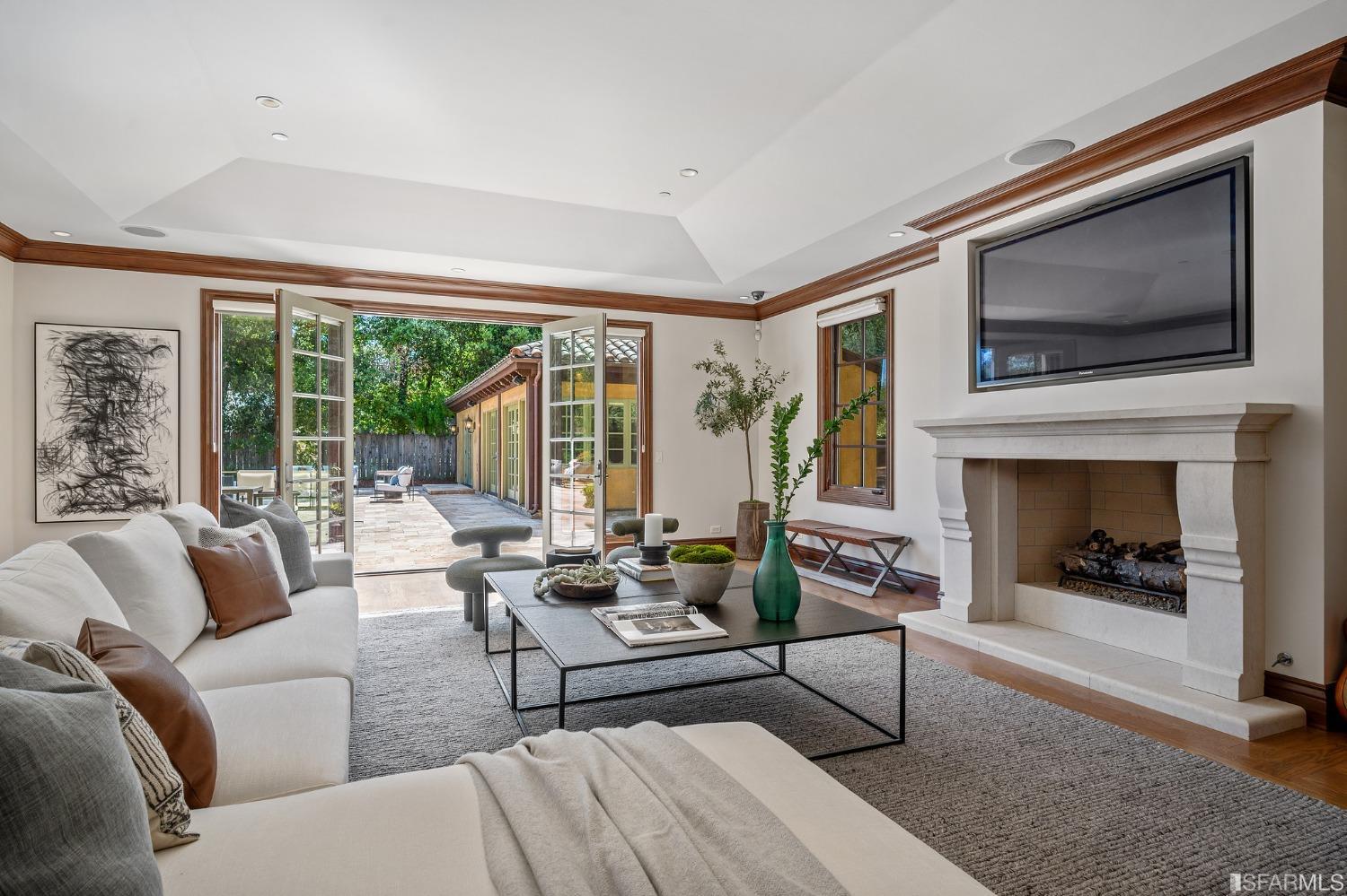 73 Irving Avenue Atherton, CA 94027 - Photo 42 of 99 a living room with furniture a flat screen tv and a fireplace