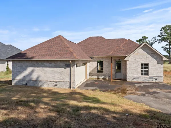 a view of a house with a yard and sitting area