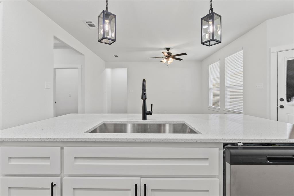 113 3rd Street Celeste, TX 75423 - Photo 14 of 39 a kitchen with a sink and a stove top oven