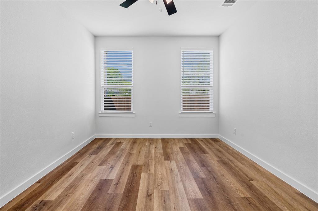 113 3rd Street Celeste, TX 75423 - Photo 23 of 39 a view of an empty room with wooden floor and a window