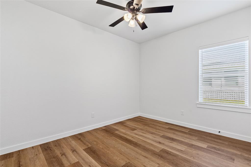 113 3rd Street Celeste, TX 75423 - Photo 32 of 39 wooden floor in an empty room with a window