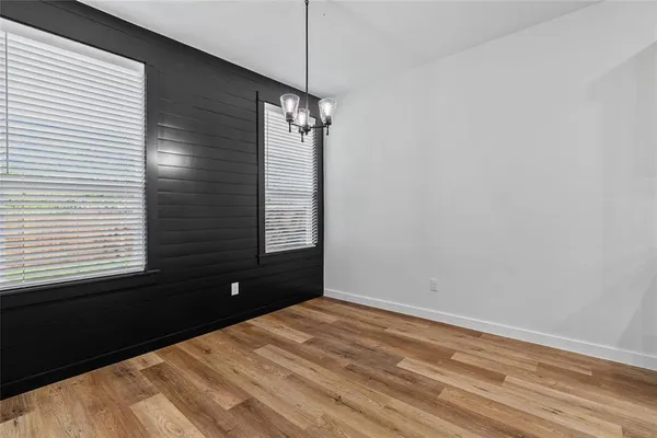 a kitchen with stainless steel appliances granite countertop a sink a stove and a wooden floor