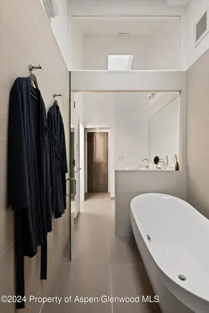 a bathroom with a bathtub and a shower