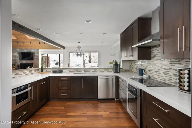 a kitchen with stainless steel appliances granite countertop a sink and stove top oven