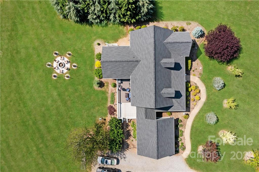 991 Golf Course Road Tryon, NC 28782 - Photo 11 of 43 an aerial view of a house with a garden and trees all around