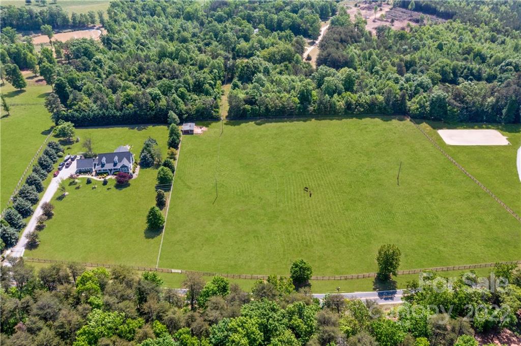 991 Golf Course Road Tryon, NC 28782 - Photo 19 of 43 an aerial view of a residential houses with outdoor space and trees all around
