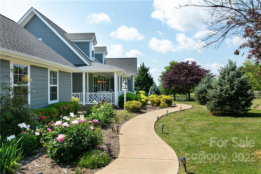 991 Golf Course Road Tryon, NC 28782 - Photo 24 of 43 a front view of a house with garden