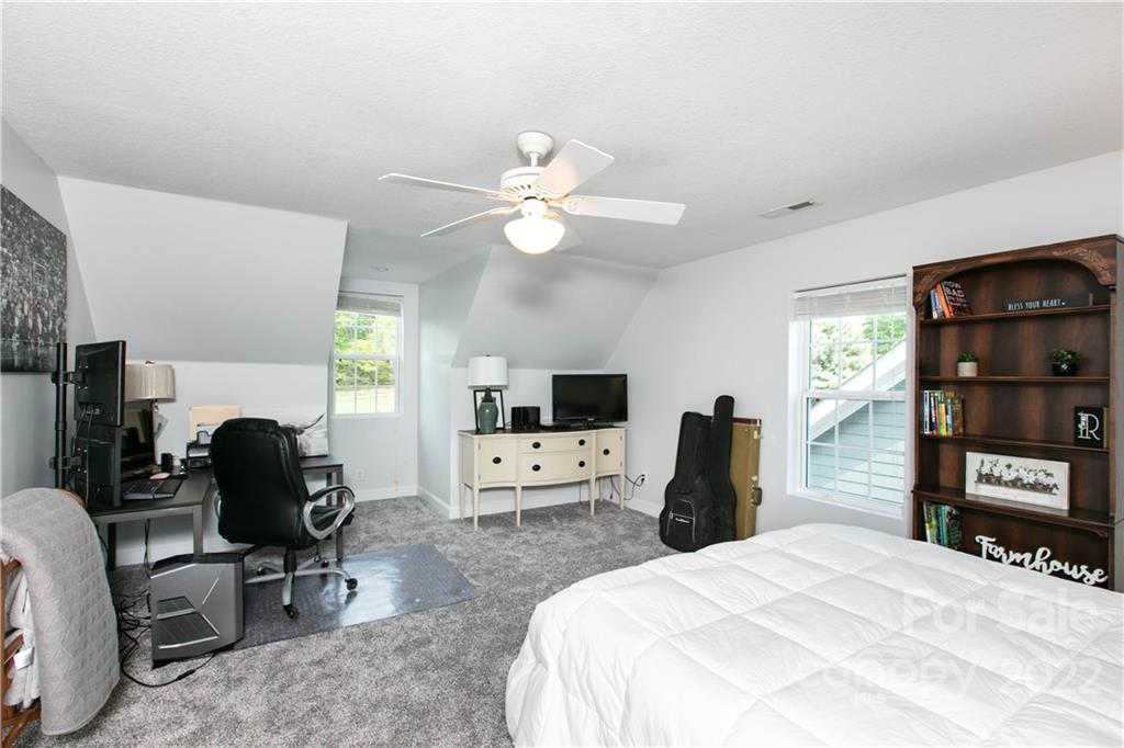 991 Golf Course Road Tryon, NC 28782 - Photo 27 of 43 a bedroom with a bed and a television