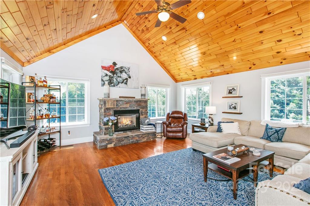 991 Golf Course Road Tryon, NC 28782 - Photo 3 of 43 a living room with furniture a fireplace and a table