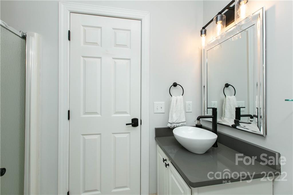 991 Golf Course Road Tryon, NC 28782 - Photo 31 of 43 a bathroom with a sink and a mirror