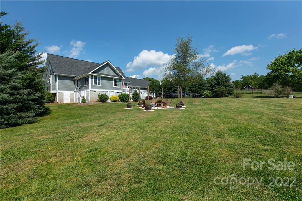 991 Golf Course Road Tryon, NC 28782 - Photo 35 of 43 a front view of a house with garden