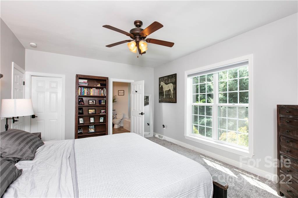 991 Golf Course Road Tryon, NC 28782 - Photo 39 of 43 a bedroom with a large bed and a window
