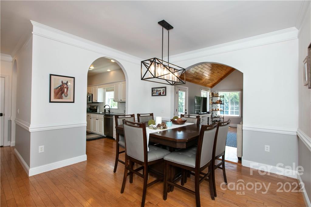 991 Golf Course Road Tryon, NC 28782 - Photo 4 of 43 a dining room with furniture a chandelier and wooden floor