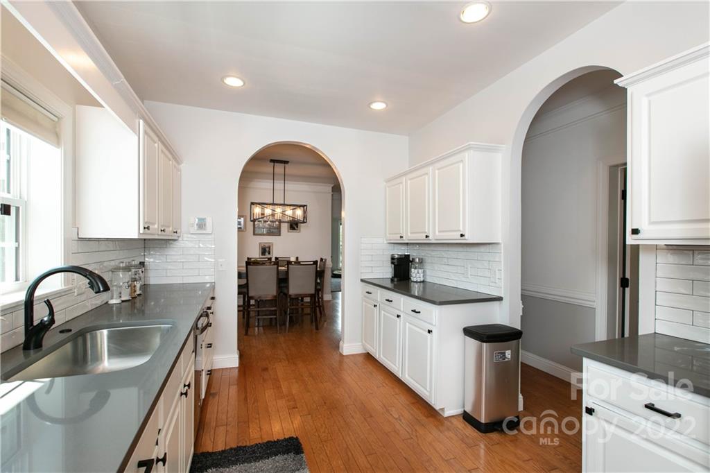 991 Golf Course Road Tryon, NC 28782 - Photo 7 of 43 a kitchen with granite countertop a sink a stove and cabinets