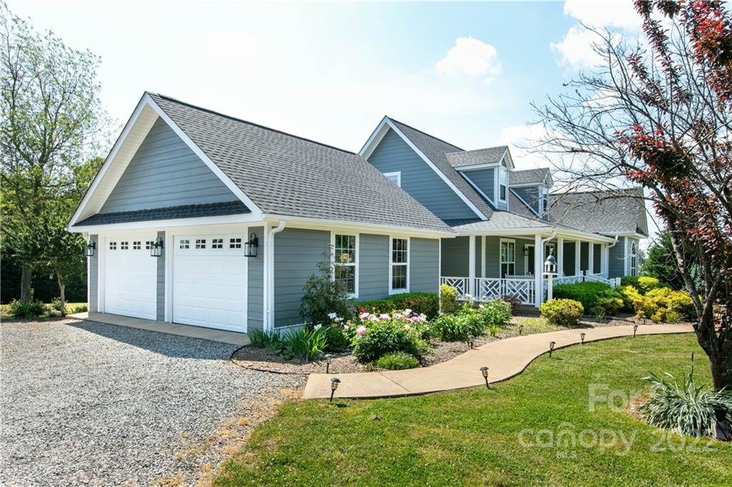 991 Golf Course Road Tryon, NC 28782 - Photo 8 of 43 a front view of a house with a yard and porch